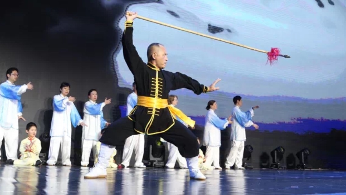 Master Stephen Lin performing a traditional spear routine on stage