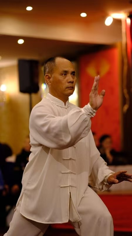 Master Stephen Lin demonstrating a traditional Tai Chi form in white uniform